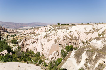 Picturesque valleys blue with artificial caves into the rocks