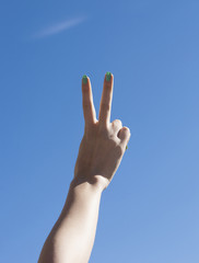 Female hand up in the sky making victory gesture
