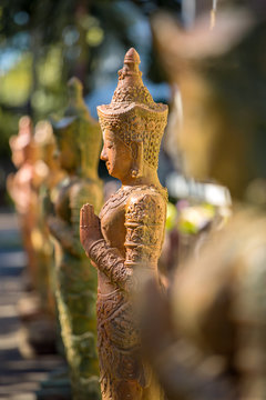 Clay praying women statue in the buddhist temple in Thailand