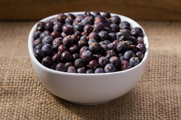 dried elderberries in small white bowl