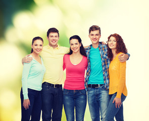 group of smiling teenagers over green background