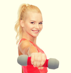 smiling beautiful sporty woman with dumbbell