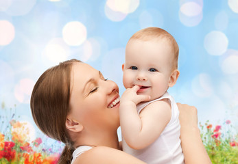 happy mother with baby over natural background