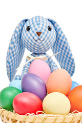 Easter Bunny and painted Eggs in basket on white background