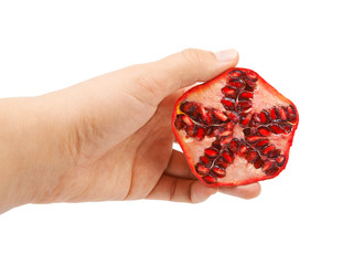 Hand holding half an pomegranate on a white background.