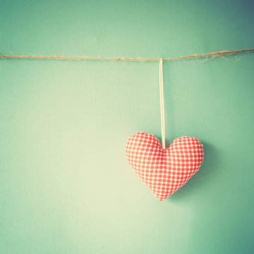 Vintage stuffed cotton heart hanging on a line
