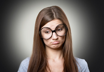 Fototapeta premium Funny pensive girl in large glasses