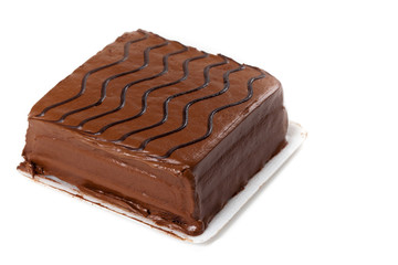 A chocolate fudge layer cake on white. Selective focus.