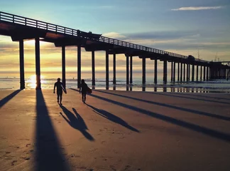 Zelfklevend Fotobehang Silhouette and Shadows of Surfers along the Pacific Ocean, USA © samantoniophoto