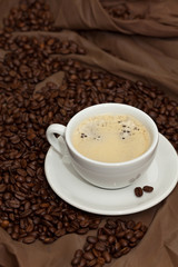 Coffee cup and beans. Selective focus.