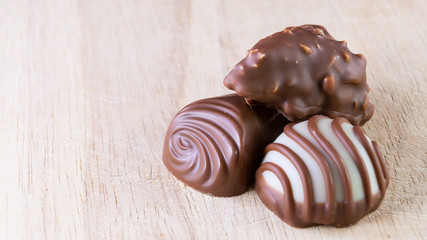Chocolate pralines on wood