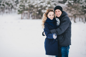 Young couple walking in a winter countryside