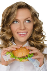 Young woman with hamburger from Euro looking away