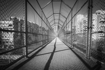 interior of a walkway bridge with protective metal mesh