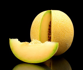 Melon galia notched with slice isolated black in studio © T. Wejkszo