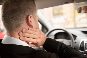 Man Suffering From Neck Pain While Driving