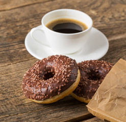 Overhead view of two tempting fresh doughnuts with their brown p