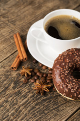 coffee and donut on wood background