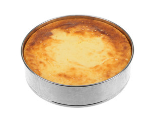 Cheesecake in aluminum pan isolated on white.