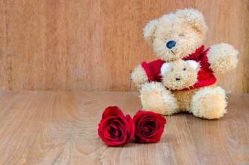 Red rose with teddy bear valentine concept on wooden background.