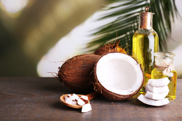 Coconuts and coconut oil on wooden table © Africa Studio