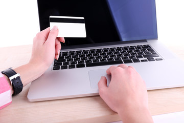 Concept for Internet shopping: hands with laptop and credit