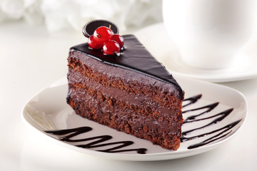 Delicious chocolate cake on plate on table on light background