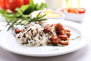 Tasty rice with meat served on table, close-up