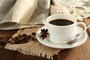 Cup of coffee with coffee beans and star anise
