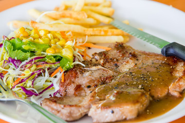 juicy grilled pork chop (neck cut) with salad