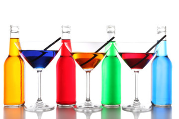 Colorful alcoholic beverages in glassware isolated on white