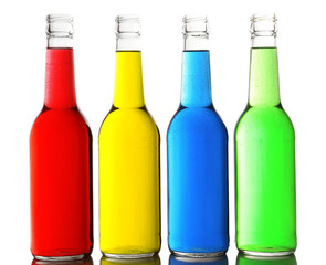 Colorful alcoholic beverages in glass bottles isolated on white