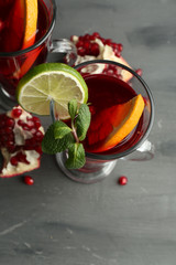 Pomegranate drink in glasses with mint and slices of orange and
