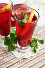 Pomegranate drink in glasses with mint and slices of orange