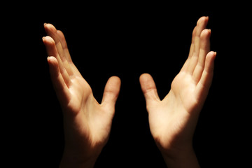 Female hands on dark background