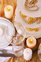 Beautiful holiday table setting in white and gold color