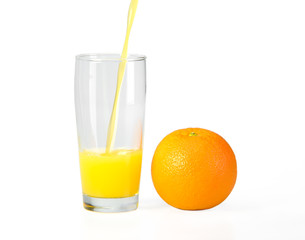 A glass of orange juice on a white background and orange