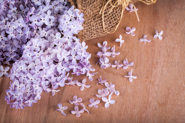 Lilac flowers on wooden background.