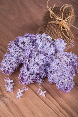 Lilac flowers on wooden background.
