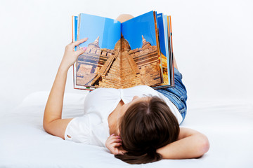 Young woman reading travel magazine