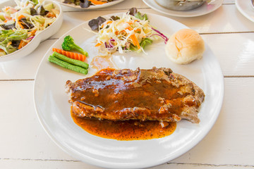 Grilled steaks,bread and vegetable salad