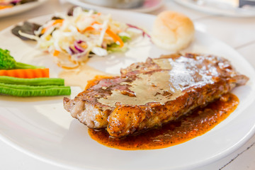 Grilled steaks,bread and vegetable salad