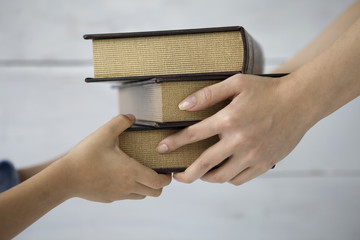 Mother are passing a book to children