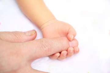 Fototapeta na wymiar lovely baby with Mam use finger