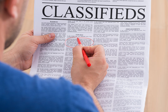 Man Looking In Classifieds For Job