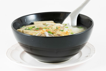 Bowl of Vietnamese pho bo,noodle soup served with onions and cil
