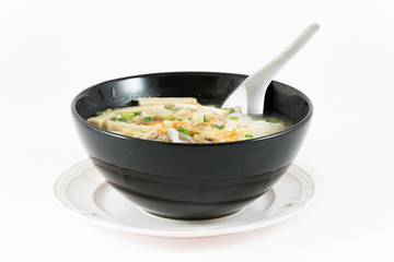 Bowl of Vietnamese pho bo,noodle soup served with onions and cil