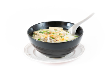 Bowl of Vietnamese pho bo,noodle soup served with onions and cil