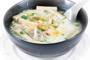 Bowl of Vietnamese pho bo,noodle soup served with onions and cil