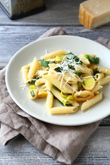 Pasta with cheese and onions on a white plate